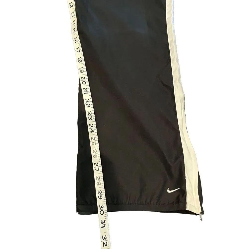 Nike black track pants with white side stripes and ankle zippers - L